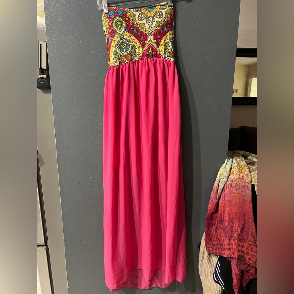 bright pink strapless maxi dress with a multi-colored printed bodice.